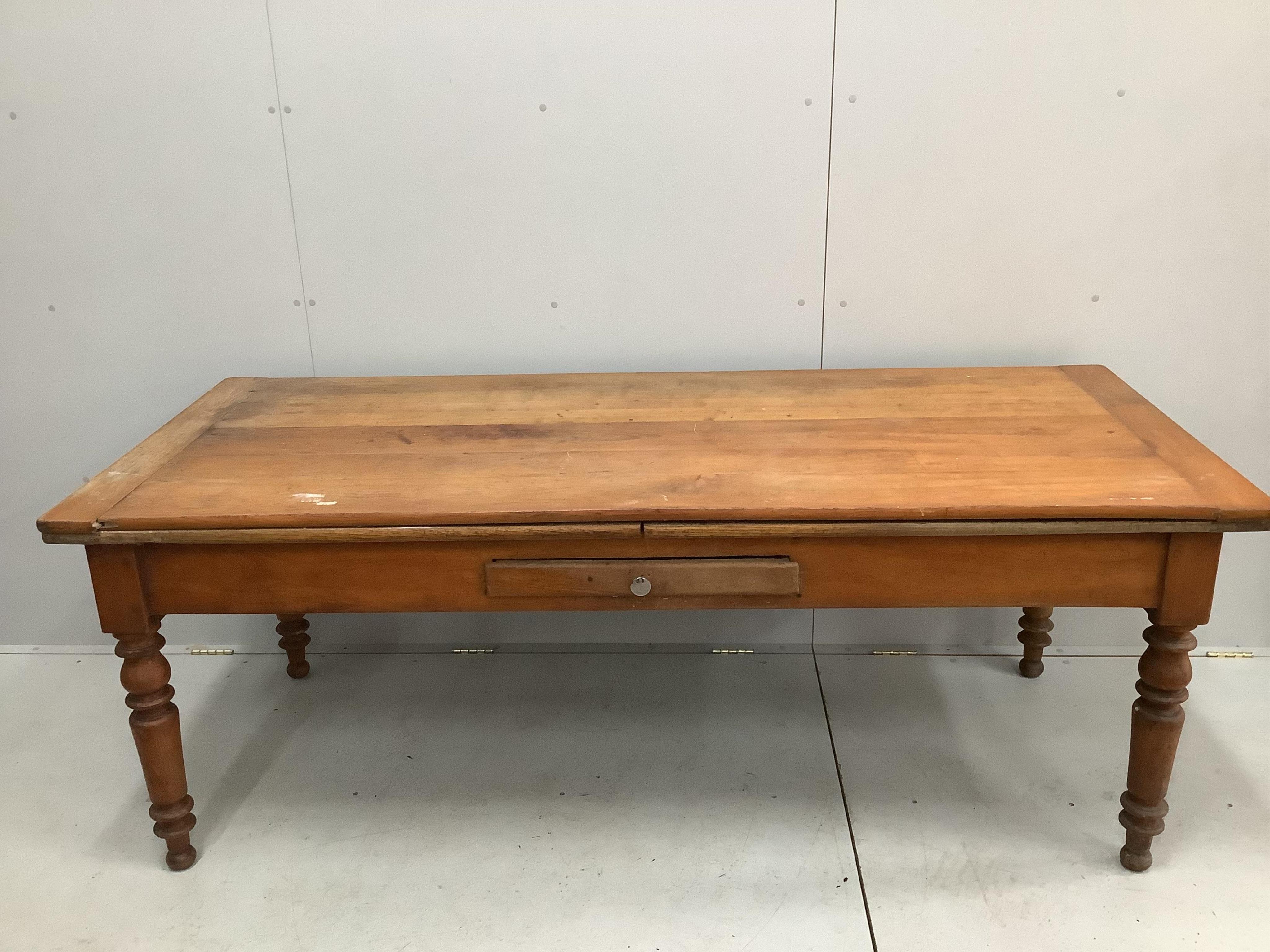 A 19th century French draw leaf kitchen table, width 200cm, depth 84cm, height 76cm. Condition - fair